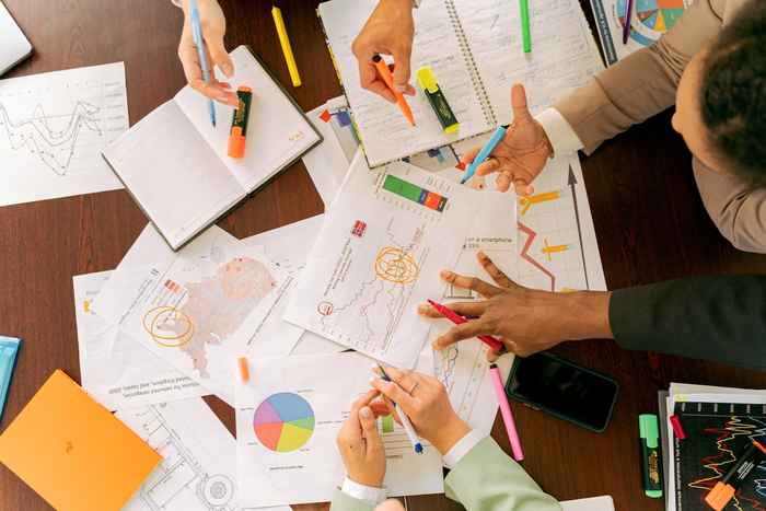 Photo of people working with different documents